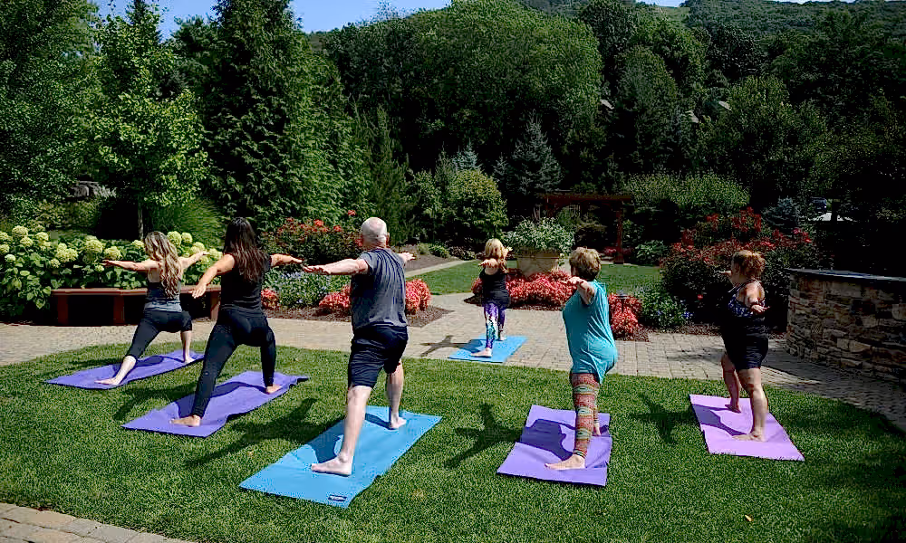 Group of people doing yoga outdoors.