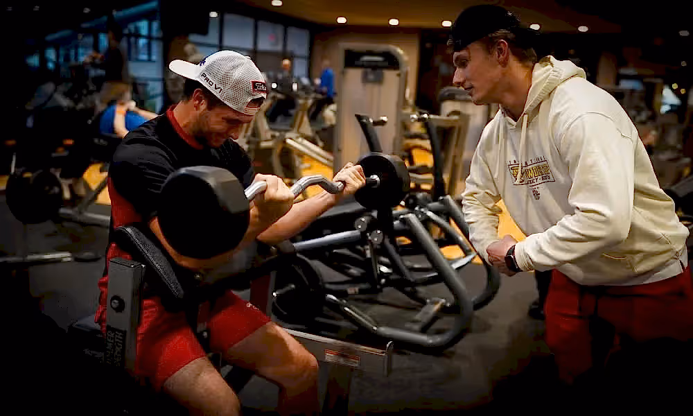 Personal training session where client is doing bicep curls. 