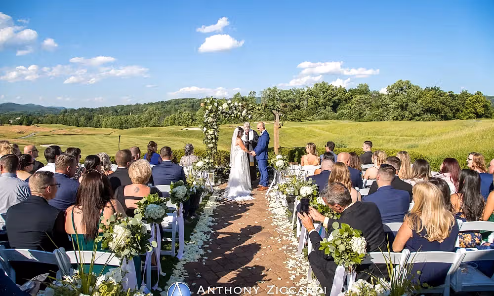 Bride and groom hold hand during their ceremony at Ballyowen Wedding Garden.