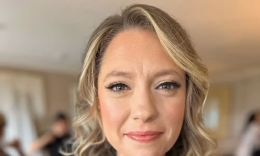 Woman with blonde curled hair. 
