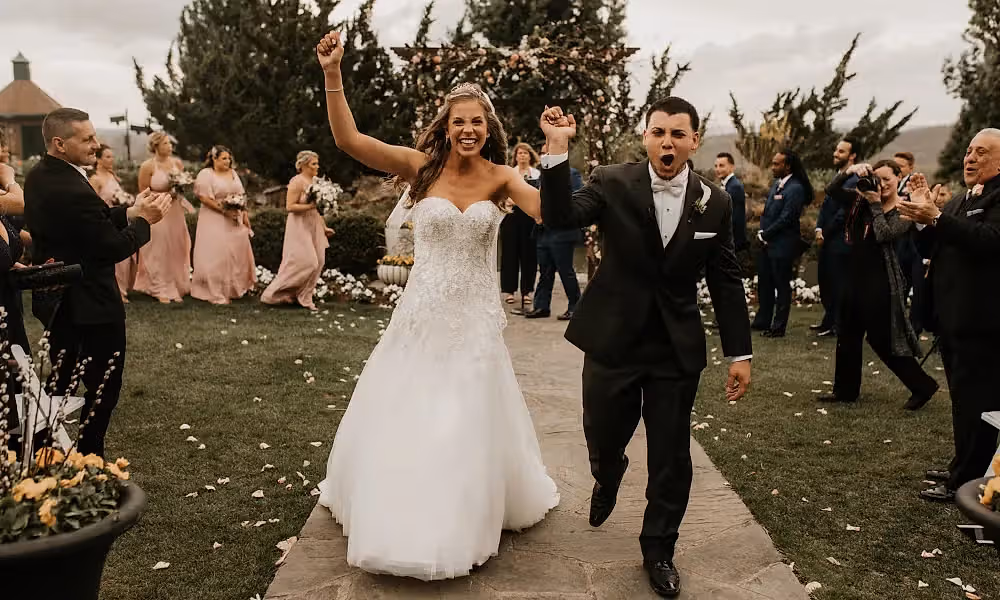 Bride and groom walk down aisle at Bride walking down the aisle at Wedding Garden ceremony space at Crystal Springs Country Club. 