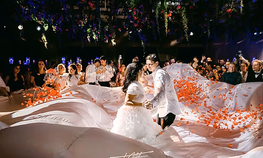 Bride and groom dancing surrounded by flowers at their wedding reception in Big Sky Pavillion.