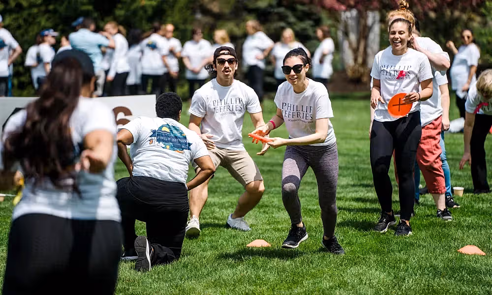 Group playing frisbee during teambuilding exercise.