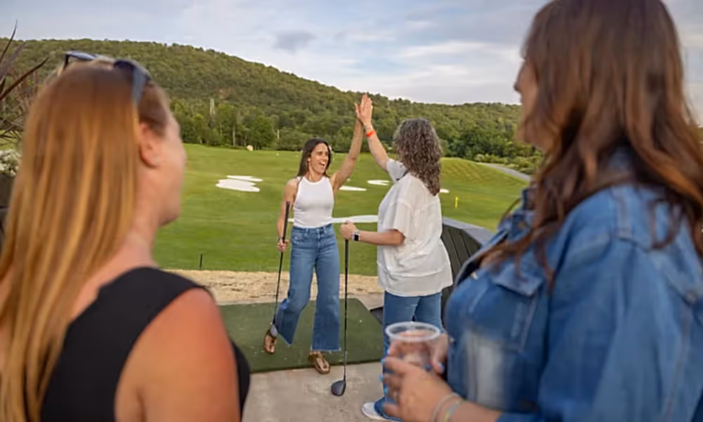 Woman high five at Black Bear Trackman Range