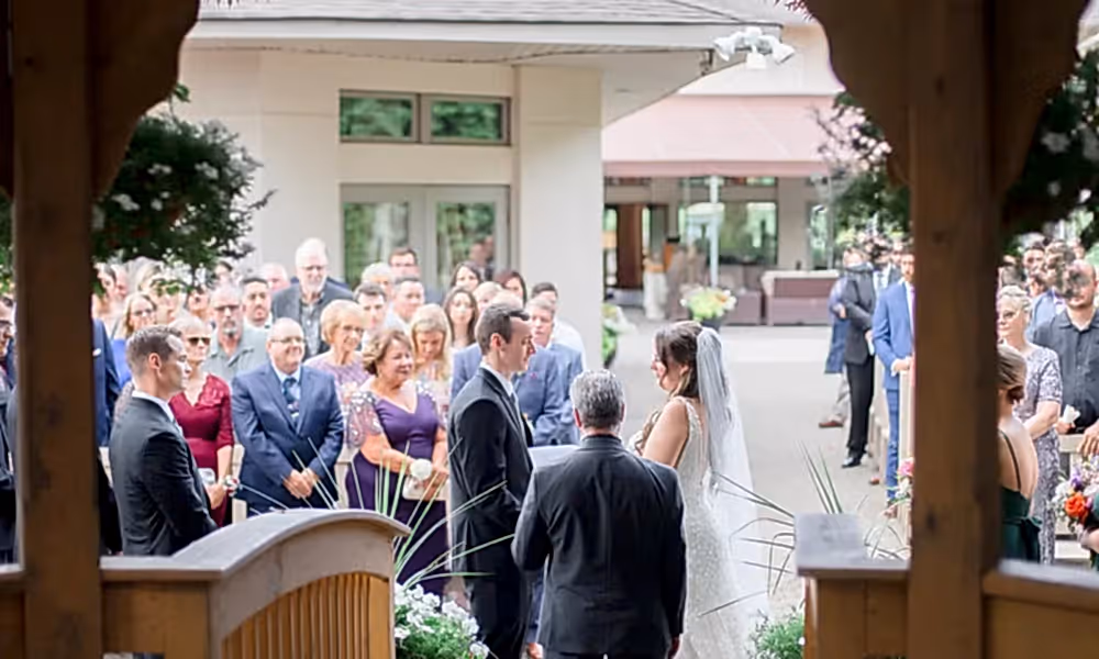 Bride and groom holding hands during ceremony at Black Bear wedding.
