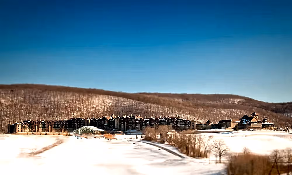 Distance exterior view of Grand Cascades Lodge in the winter