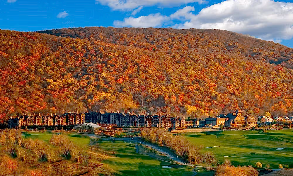 View of fall mountains behind Grand Cascades Lodge at Crystal Springs Resort in NJ