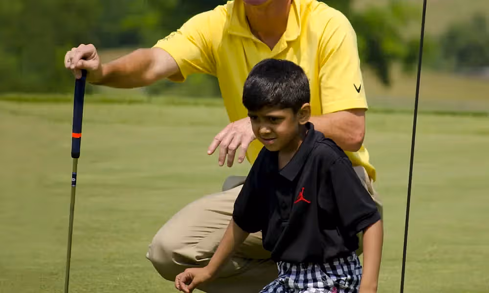 LeadBetter Golf Academy instructor teaching young boy to golf