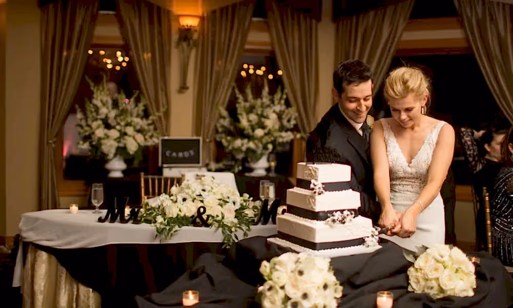 Bride and groom cutting wedding cake at Black Bear wedding reception