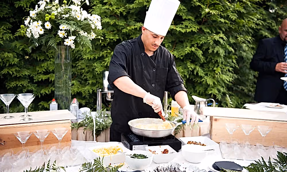 Chef cooking fresh food at cocktail hour