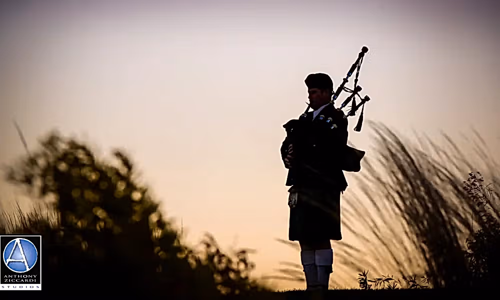 Silhouette of bagpiper playing