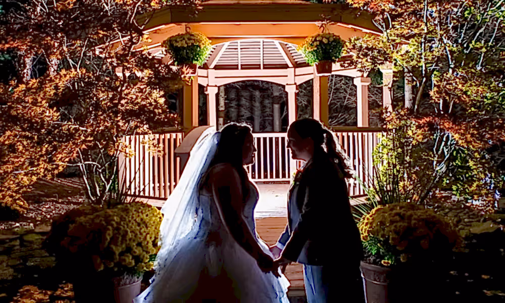 Brides in front of lit up Black Bear gazebo at night