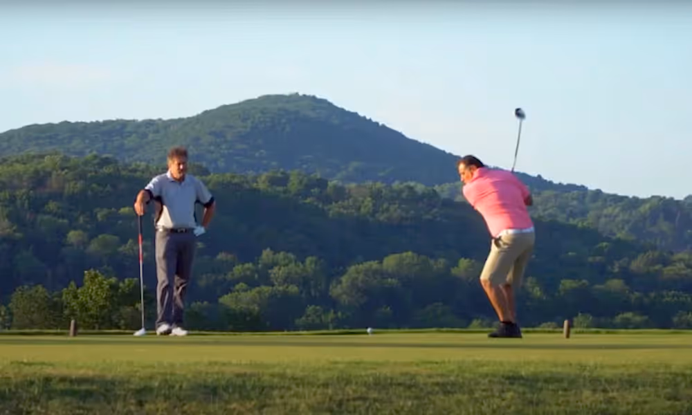 Two Golfers making their swings at a golf course near NYC