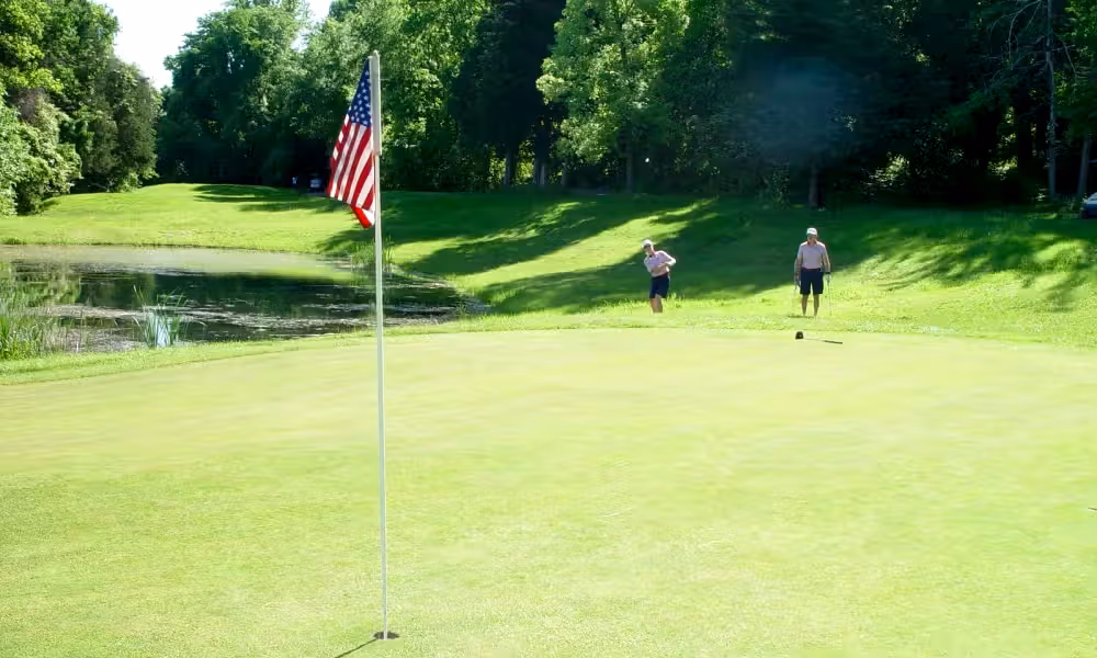 Two golfers on the green of  Minerals Golf Club at Crystal Springs Resort