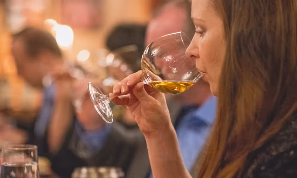 Woman drinking white wine.