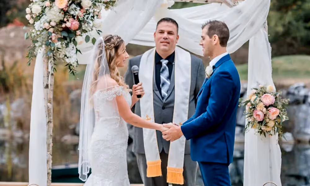 Romantic couple holding hands at the alter