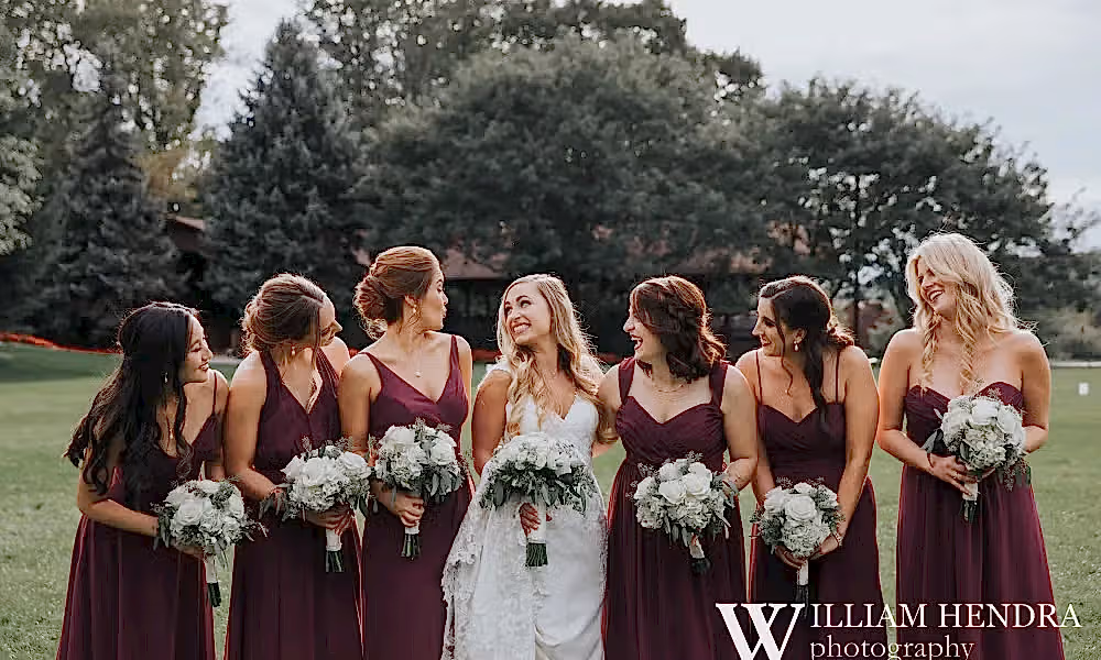 Bride smiling with bridesmaids 