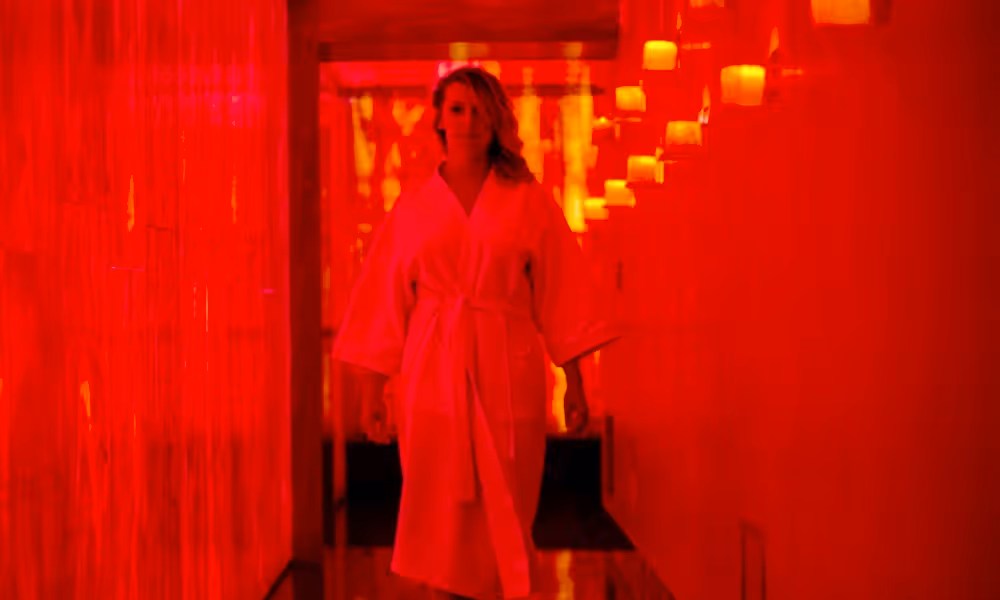 Woman walking down Reflections Spa hallway.