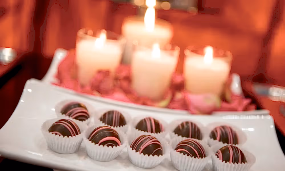 Chocolates with lit candles behind.