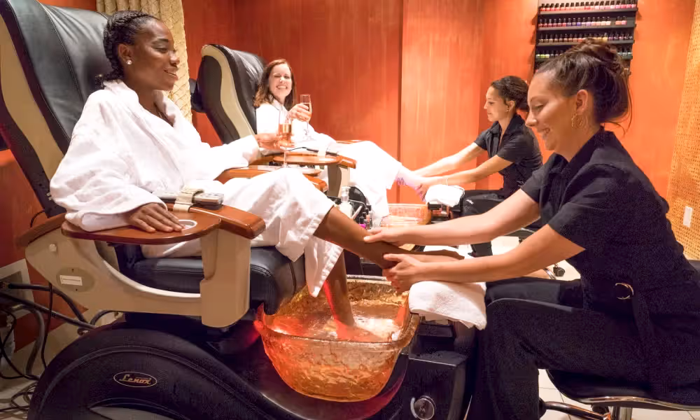Two guests in white robes getting a pedicure at Reflection Spa in NJ.