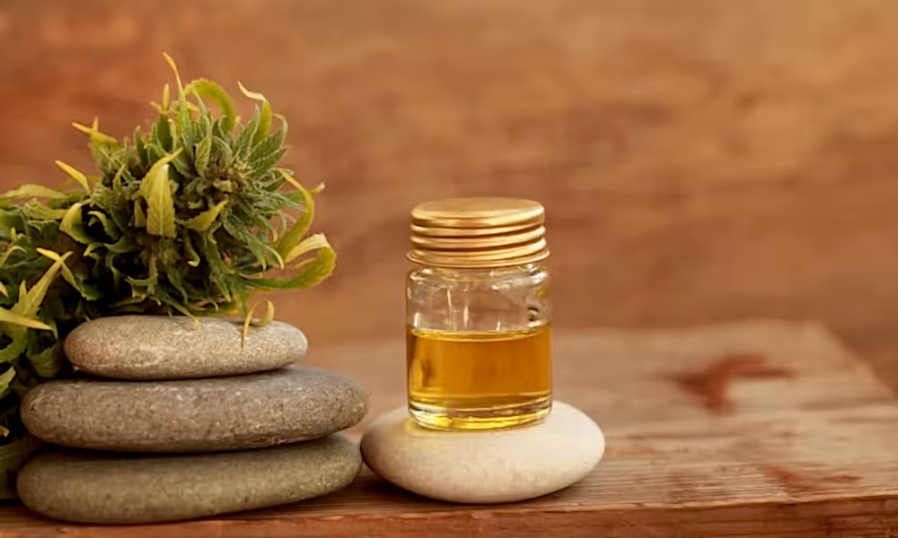 CBD oil in a jar on top of a rock.