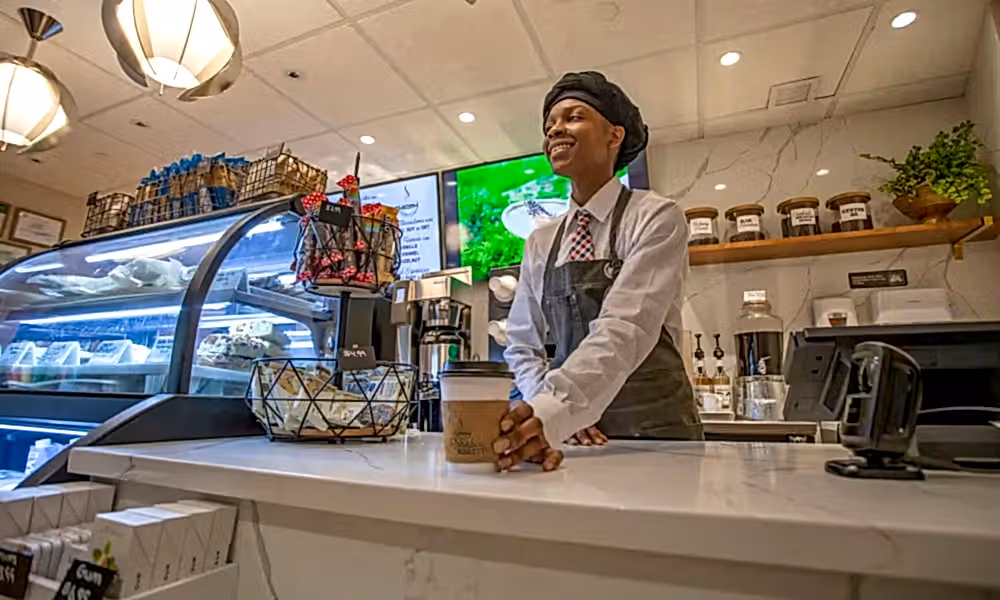 Rosebud Roasters barista serving coffee