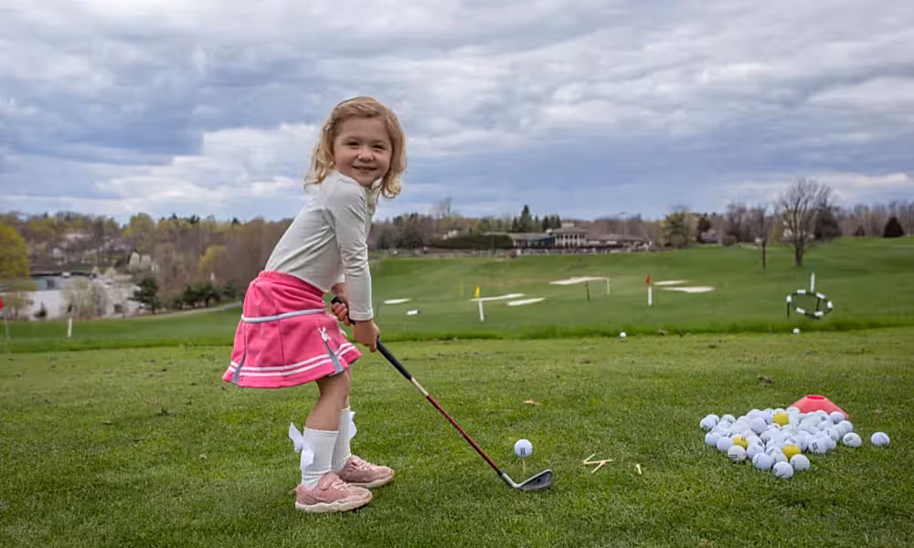 Young girl learning to golf at Crystal Springs Resort