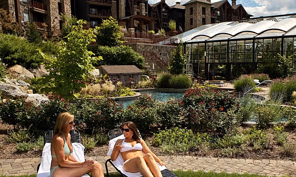 Two women sunbathing at Biosphere outdoor pool