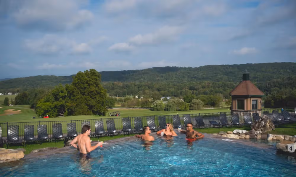 Group of friends relaxing in Vista 180 pool.
