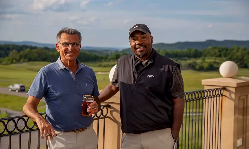 Two guys on the outdoor patio of a golf club at Crystal Springs Resort