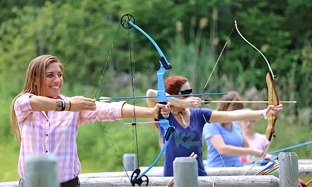 Group of people doing archery practice.