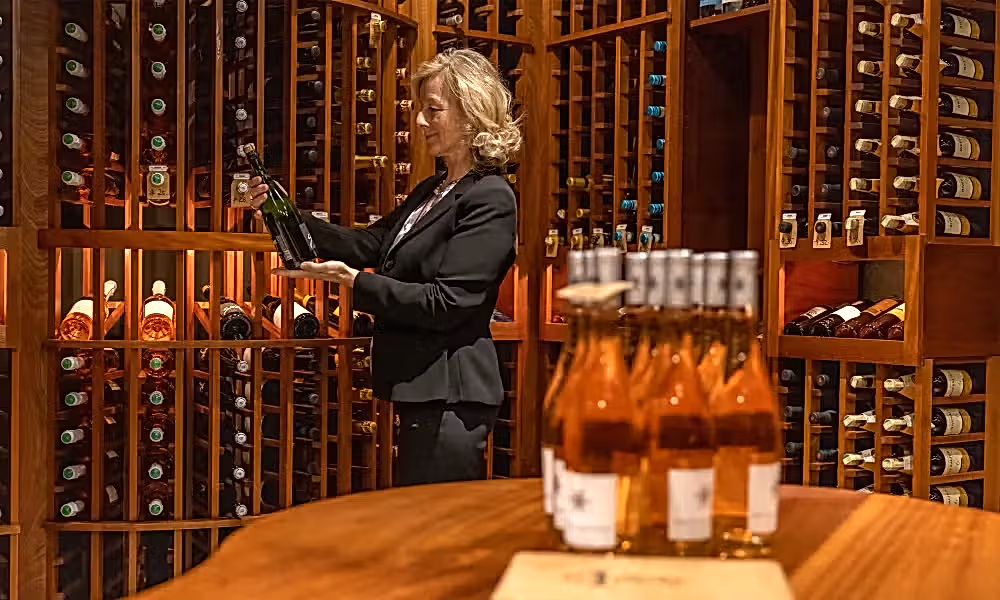 Sommelier selecting wine at The Curator