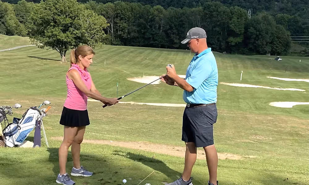 Golf Instructor with Leadbetter Golf Academy teaching woman to golf