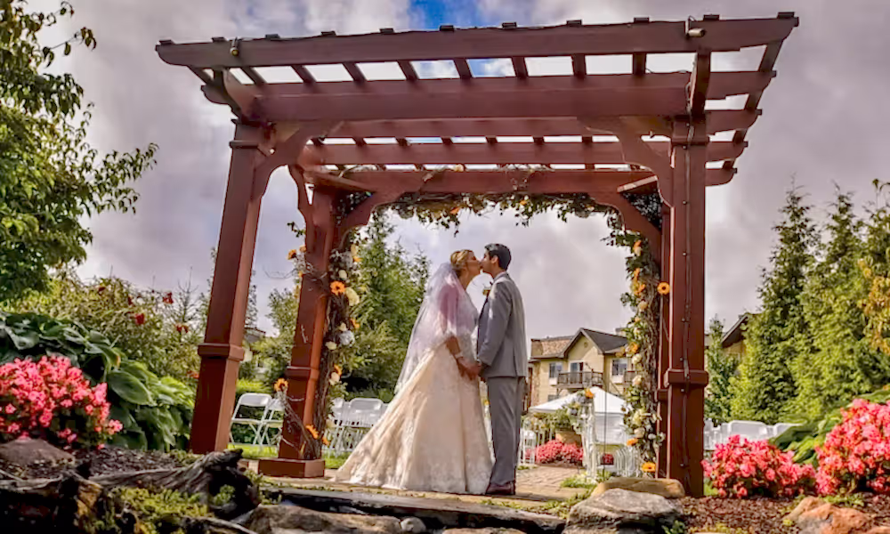 Wedding couple kissing under alter