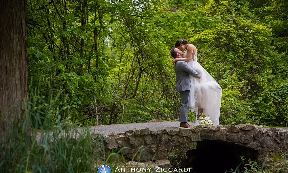 Groom lifting up bride in wedding photo op