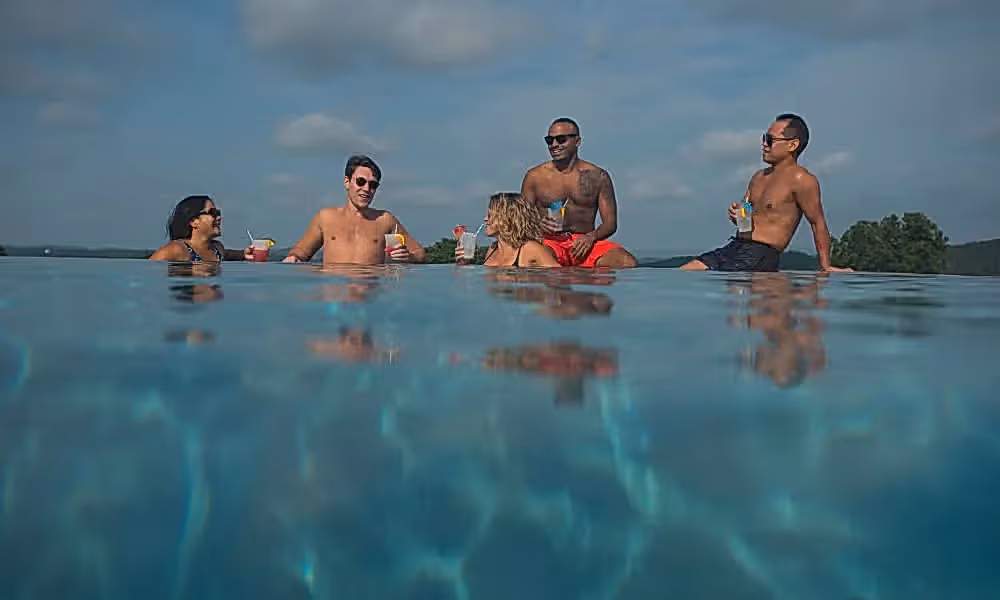 Group of friends drinking in vista 180 pool.