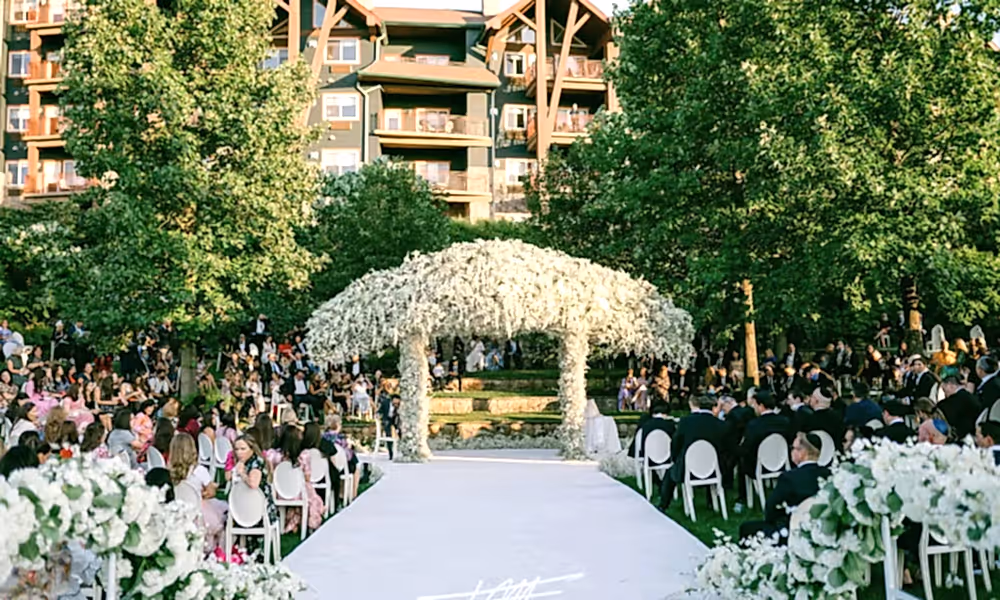 White aisle of wedding ceremony in outdoor amphitheater.