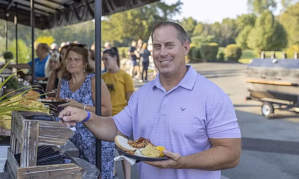 Man grabbing food from buffet.
