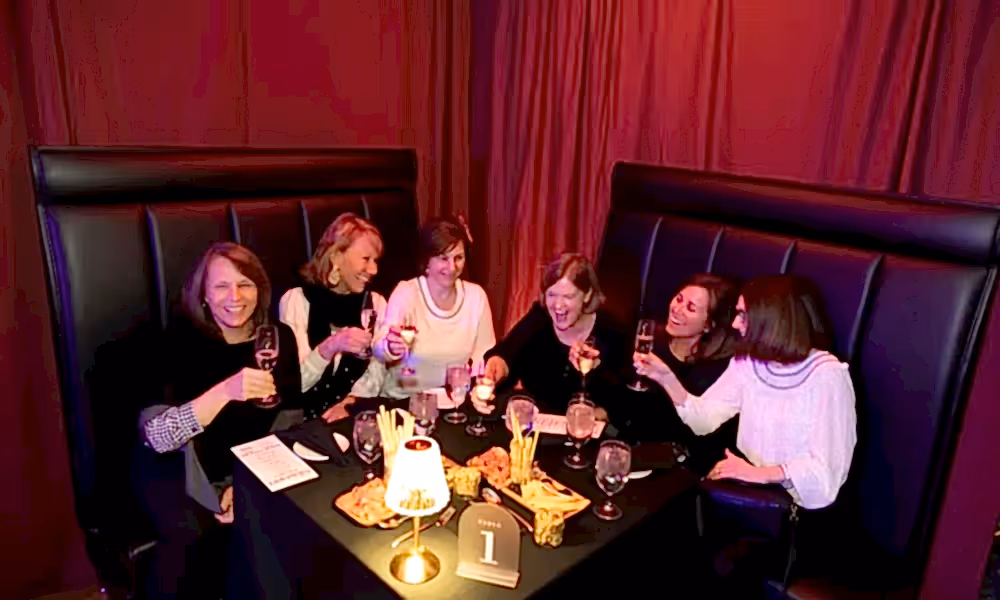 Group of girlfriends enjoying drinks at Crystal Cabaret. 