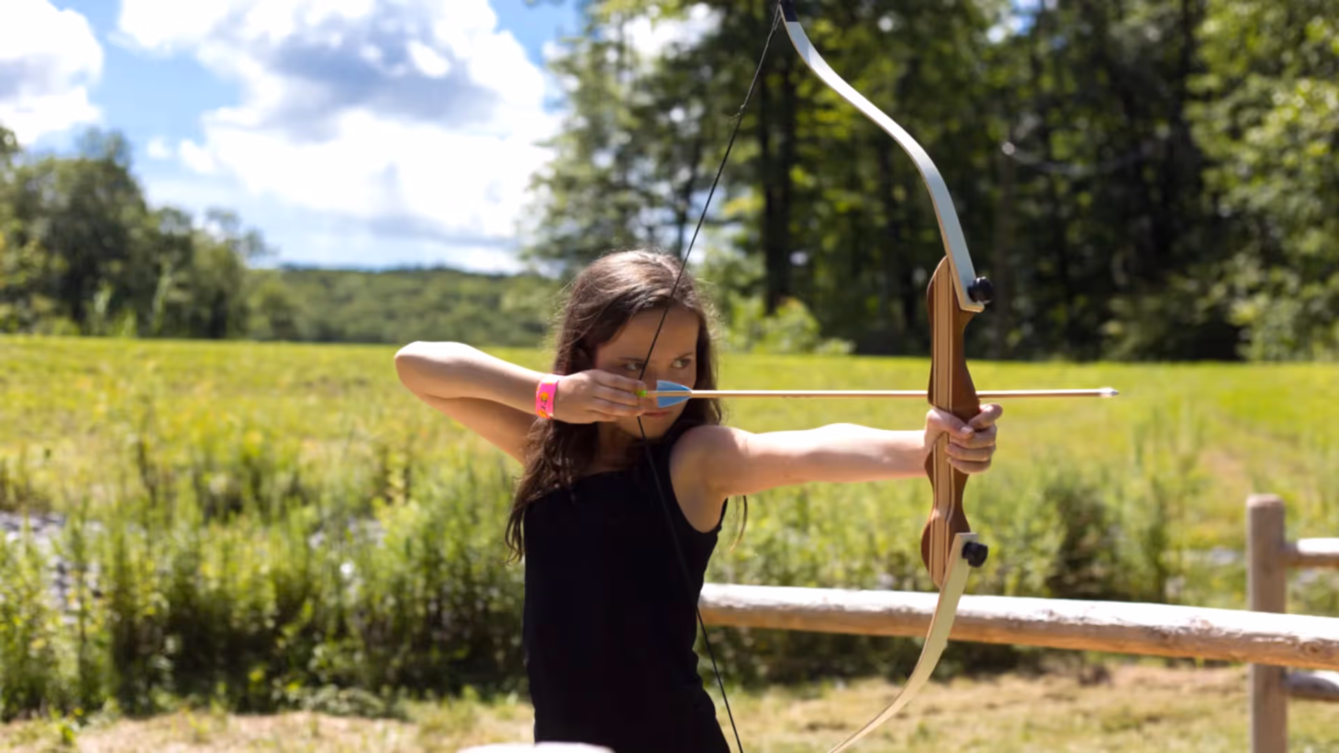 Girl shooting an arrow. 