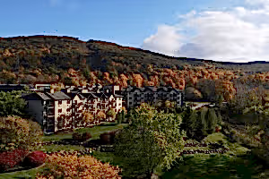 Minerals Hotel sits in front of fall mountain range.