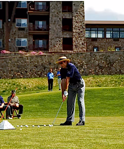 Man golfing at a driving range at Crystal Springs Resort