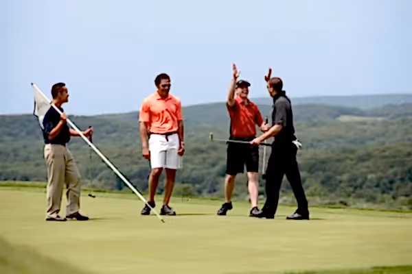 Four golfers on the putting green