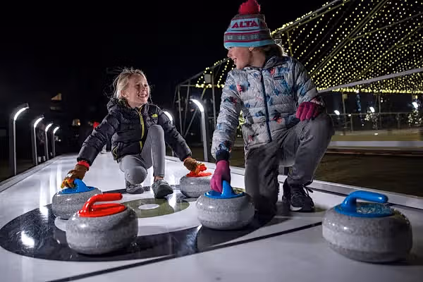 Two kids curling.