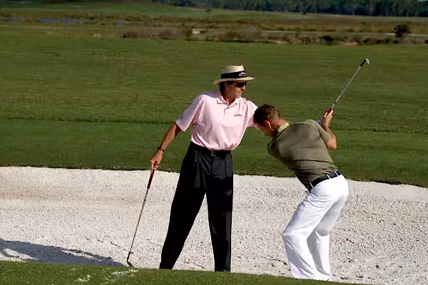 David Leadbetter teaching man how to golf at Crystal Springs Resort