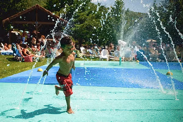 Child running through spray ground at Minerals Hotel