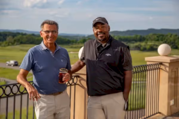Two guys on the outdoor patio of a golf club at Crystal Springs Resort