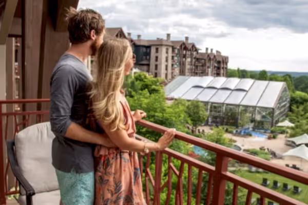 Couple enjoying breakfast while overlooking their balcony view from Grand Cascades Lodge