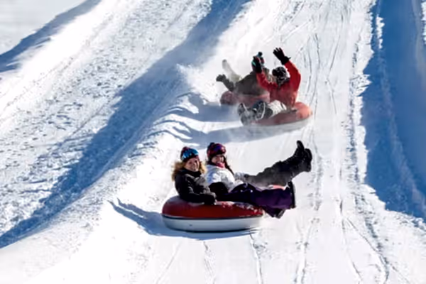 People snowtubing.