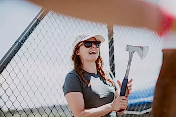 Women holding axe at axe throwing game